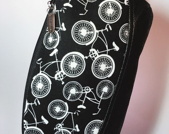 Wristlet, Bicycles, white bikes on black cotton fabric and vegan black vinyl with a “journey” charm