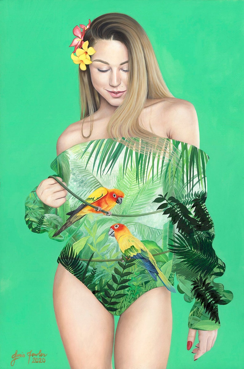 May include: A woman with long blonde hair wearing a green, off-the-shoulder top with a tropical print. The top features two parrots, one orange and yellow and the other yellow and green, perched on branches. The woman is standing against a green background.