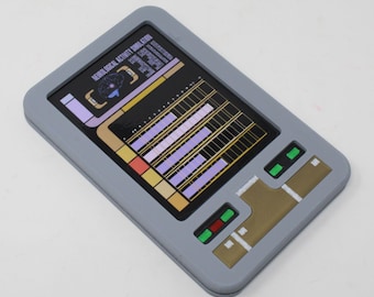 May include: A rectangular gray handheld device featuring a screen displaying a brain icon and the text NEUROLOGICAL ACTIVITY SIMULATION. The interface includes purple bar graphs, gold accents, and small green and red rectangular buttons.