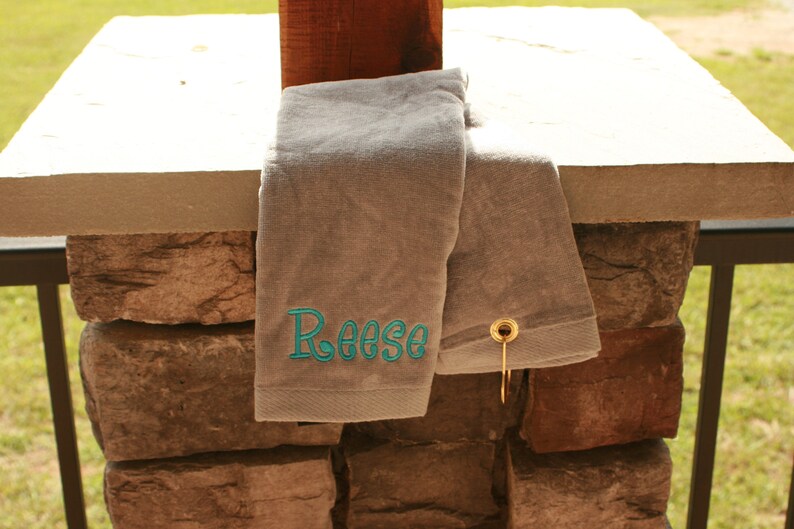 gray golf towel with turquoise embroidered name