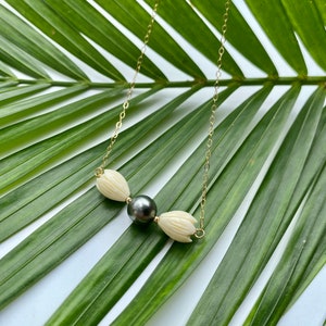 Pikake flowers encasing a Tahitian pearl in your choice of material
