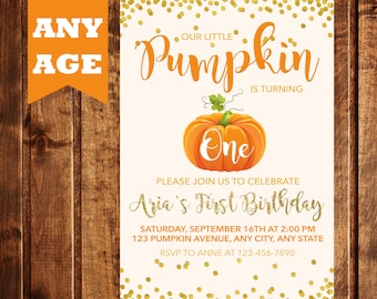 May include: A white invitation with gold glitter confetti. The text reads "Our Little Pumpkin is Turning One. Please join us to celebrate Aria's First Birthday. Saturday, September 16th at 2:00 PM. 123 Pumpkin Avenue, Any City, Any State. RSVP to Anne at 123-456-7890". An orange pumpkin with a green stem and leaves is in the center of the invitation.
