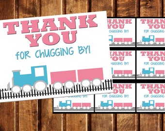 May include: A thank you card featuring a blue and pink train design. The card reads "Thank You for Chugging By!" and includes six smaller thank you tags with the same design.