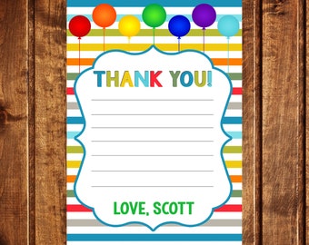 May include: A printable thank you card with a colorful rainbow balloon design. The card has a white background with a blue border and a space for writing a message. The text "THANK YOU!" is written in colorful letters at the top of the card. The text "LOVE, SCOTT" is written at the bottom of the card.