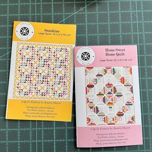 May include: Two quilt pattern covers are displayed. The "Sunshine" pattern is yellow with a colorful geometric design. The "Home Sweet Home Quilt" pattern is pink with a patchwork design. Both patterns are by Jessica Dayon and include social media links.
