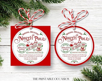 Puede incluir: Etiquetas de regalo navideñas rojas y blancas con el texto "Special Delivery North Pole Hot Chocolate Bomb". Las etiquetas son cuadradas y circulares, con un borde rojo y una cuerda roja y blanca. Las etiquetas incluyen instrucciones de uso.