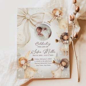 May include: A memorial card with a soft, watercolor design. The card features a photo of a baby, surrounded by illustrations of angels playing trumpets. Text includes "In Loving Memory" and "Celebrating the Life of Sofia Miller."