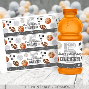 May include: Three printable labels for juice bottles featuring a sports theme. The labels are white with a gray and black border. The labels have a pattern of various sports balls, including basketballs, footballs, volleyballs, and baseballs. The labels also have the text "Happy Birthday Oliver" and the number "5".
