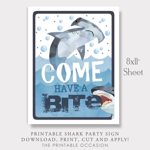 May include: Printable 8x11 inch sign featuring a watercolor illustration of two sharks with the text "Come Have a Bite". The sign is perfect for a shark-themed party.