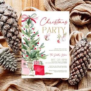 Watercolor red bow Christmas tree invitation for a holiday gathering or office party, displayed flat with glitter pinecones, ornaments, and beige ribbon on a rustic brown fabric background. The festive scene highlights the invitation’s red gift boxes, gold lettering, and soft watercolor details, perfect for Christmas or winter celebration invitations.