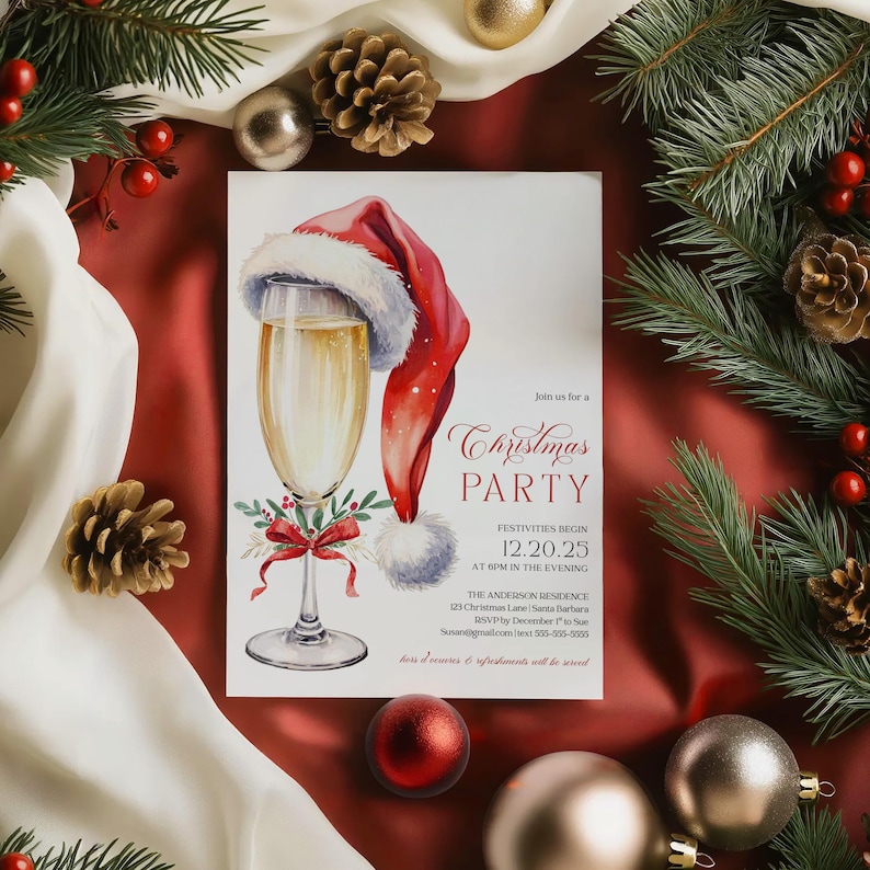 Holiday cocktail invitation with champagne glass, Santa hat, and festive red bow design, ideal for adult Christmas parties and Friendsmas events. The elegant layout makes it easy to personalize for home gatherings, holiday dinners, or office Christmas parties. Mockup styling features satin fabric, pinecones, and holiday ornaments, creating a warm and festive seasonal display.