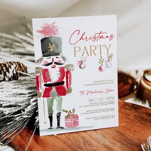 Editable Nutcracker Christmas Party Invitation featuring a watercolor nutcracker soldier in red and green attire with gold accents, festive ornaments, and holiday typography. Displayed standing on a wooden surface surrounded by pinecones, frosted greenery, and cozy winter textures, creating a warm Christmas party atmosphere.