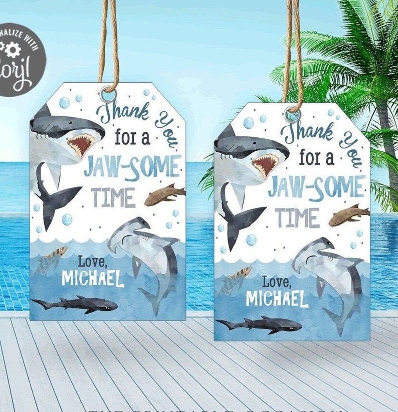 May include: Two blue and white shark-themed thank you tags with the text "Thank you for a jaw-some time" and "Love, Michael".