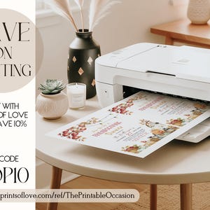 May include: A white printer printing a colorful invitation with floral and fruit illustrations. The invitation is for a Thanksgiving dinner. A black vase, a succulent, and a candle are on the table. Text on the left says "SAVE ON PRINTING".