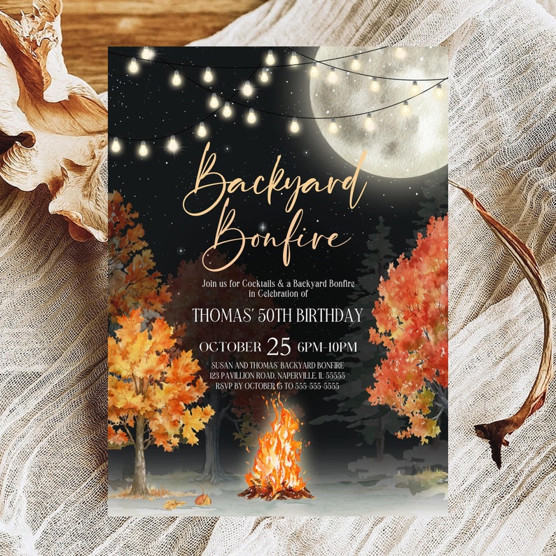 Soft evening bonfire birthday invitation design highlights glowing string lights, bright fire flames, autumn leaves, and night sky details. Elegant lettering keeps the layout refined and easy to read. Card stands on a light neutral surface with a softly blurred outdoor background. Bokeh lights and gentle focus create a romantic backyard party ambiance.