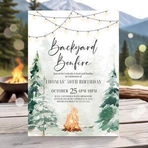 May include: A white invitation card with the text "Backyard Bonfire" in elegant script. The invitation includes details for Thomas' 50th birthday celebration, with a watercolor illustration of a bonfire and pine trees. The event is on October 25th.