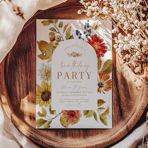 May include: A rectangular birthday party invitation card featuring a central white arch with gold text that reads: please join us for a birthday PARTY to celebrate Olivia St. James, Saturday, November 25th 2026 at 2pm, 123 Autumn Avenue, Chicago.