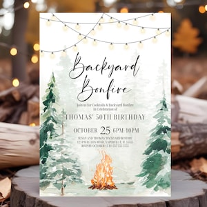 May include: A white invitation card with the text "Backyard Bonfire" in elegant script. The invitation includes details for Thomas' 50th birthday celebration, with a watercolor bonfire and pine trees design. The date is October 25.