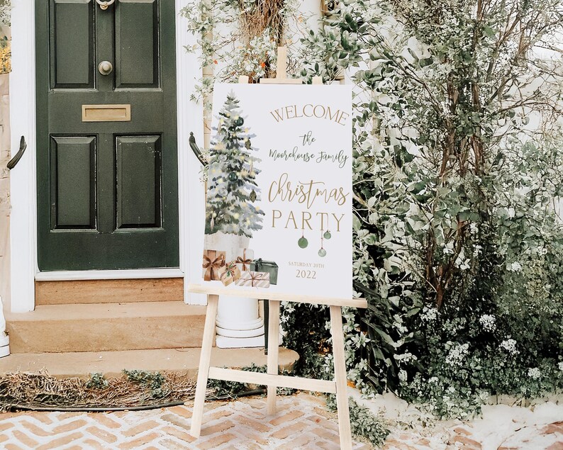 Elegant Christmas tree welcome sign for holiday parties, editable in Corjl. The printable Christmas sign features a green watercolor tree with lights, ornaments, and gift boxes, customized with family name and event date. Displayed outdoors on a wood easel in front of a green door surrounded by greenery, the mockup highlights how beautiful this editable Christmas party sign looks when welcoming guests to a cozy winter gathering.