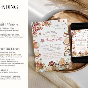 Printable fall party invitation with watercolor apples, pumpkins, hay bale and autumn leaves framing warm seasonal lettering and editable event details. The design combines rustic harvest colors with cozy fall elements. A phone and invitation are placed on a wooden tray with pampas grass and soft fabrics showing how the invitation can be used digitally or printed.