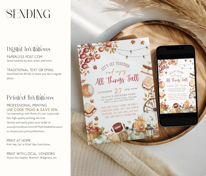 Printable fall party invitation with watercolor apples, pumpkins, hay bale and autumn leaves framing warm seasonal lettering and editable event details. The design combines rustic harvest colors with cozy fall elements. A phone and invitation are placed on a wooden tray with pampas grass and soft fabrics showing how the invitation can be used digitally or printed.