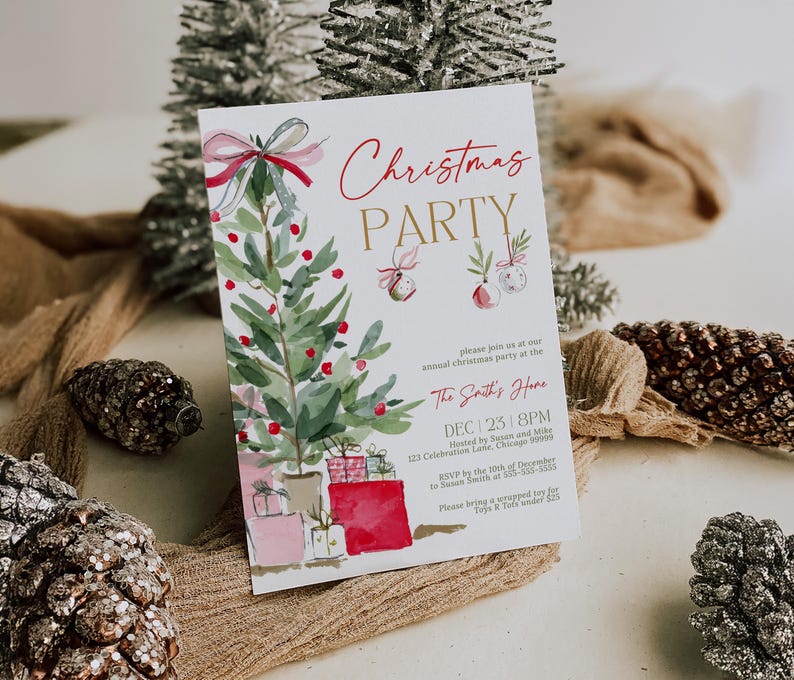 Editable Christmas invitation template with watercolor red bow and ornaments, styled at an angle on neutral linen with frosted pinecones and greenery. The realistic lighting and texture emphasize the quality of the printed card, showcasing a warm natural holiday setting ideal for family gatherings or work parties.