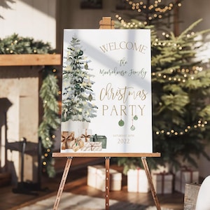 Stylish Christmas dinner party welcome sign printable featuring a gold and green festive tree with wrapped presents, editable text fields, and elegant holiday typography. This editable Corjl sign is shown printed on a wood easel beside a glowing Christmas fireplace and garland, perfect for family parties or winter gatherings. The cozy mockup captures the charm of this printable Christmas decor and how it sets the tone for an unforgettable celebration.