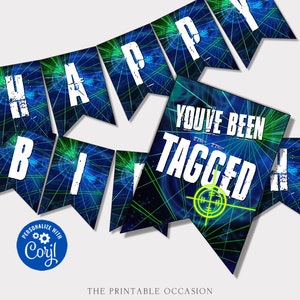 May include: A laser tag themed party banner featuring blue and green light patterns on pennant flags. The white text reads HAPPY BIRTHDAY and YOU'VE BEEN TAGGED, accompanied by a yellow crosshair graphic and a blue Corjl logo in the corner.