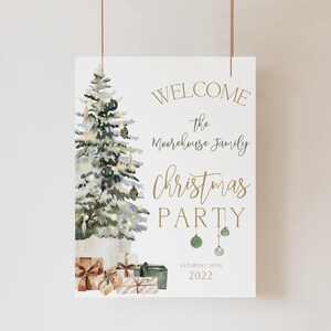 Editable Christmas welcome sign template with a watercolor holiday tree, gold ornaments, and matching wrapped gifts at the bottom. The elegant design reads “Welcome The Moorehouse Family Christmas Party,” fully customizable online. Shown hanging against a neutral beige wall, this printable Christmas party sign is ideal for holiday dinners, office events, and festive home gatherings, blending modern elegance with seasonal charm.