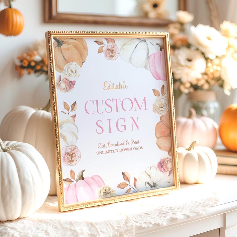 Editable fall pumpkin birthday sign with blush pink and ivory watercolor pumpkins, soft beige and rose florals, and golden fall leaves. Displayed in a gold frame on a white dresser with neutral fall props including lace fabric, mini pumpkins, and a dried floral arrangement. Text on the sign reads Editable Custom Sign in pink and brown serif fonts. Perfect for a girl’s fall birthday party or autumn-themed celebration.