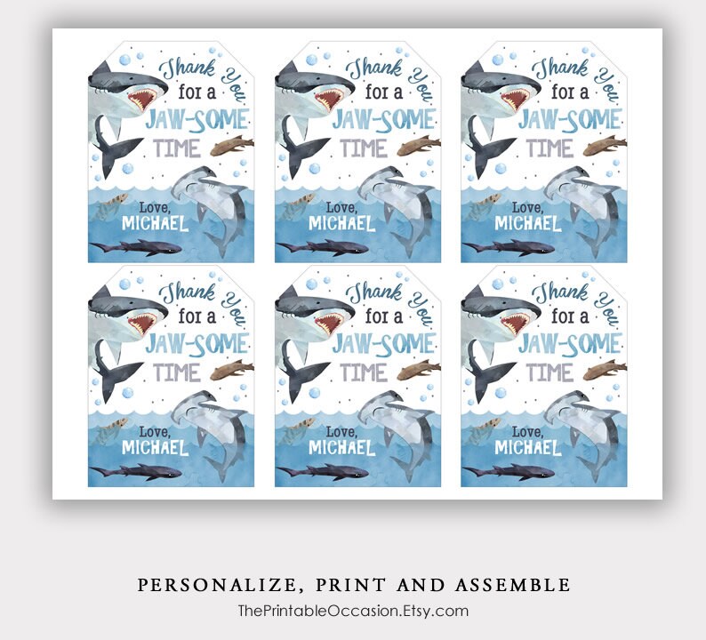 May include: Six blue and white thank you tags with a watercolor illustration of a shark. The text on the tags reads "Thank you for a Jaw-some time. Love, Michael."