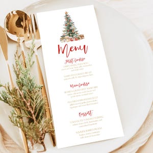May include: A white menu card with a watercolor Christmas tree illustration and the word "Menu" in red script. The menu lists courses such as Crispy Peking Duck Roll and Chocolate Fondant Pudding. Gold cutlery and greenery are in the background.