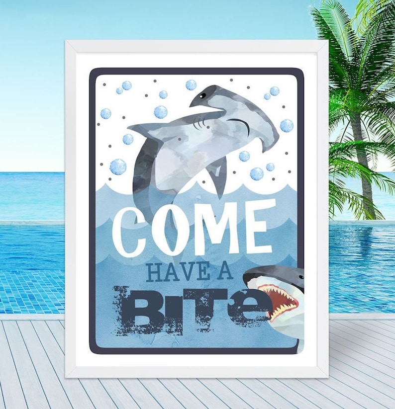 May include: A watercolor illustration of two sharks with the text "Come Have A Bite" in a blue and white frame. The sharks are in the ocean with bubbles around them.
