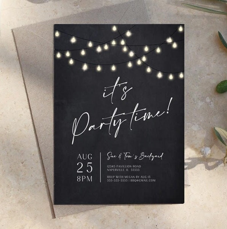 Black birthday party invitation with glowing string lights across the top and large white It's Party Time lettering. The modern layout includes customizable party details beneath the main wording. The printable invitation is displayed on a neutral stone surface with subtle greenery nearby. The design works well for an adult birthday, backyard party, BBQ or casual outdoor gathering.