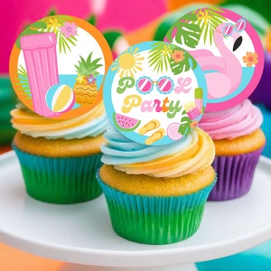 May include: Three cupcakes decorated with colorful round toppers featuring summer pool party themes. One topper has a pink flamingo with sunglasses, another has a pineapple and beach ball, and the third has a watermelon, flip flops, and the text "Pool Party".