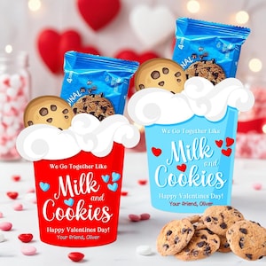 May include: Two decorative cups, one red and one blue, each filled with cookies and a blue snack pack. The cups read "We Go Together Like Milk and Cookies" with hearts, and "Happy Valentines Day!"