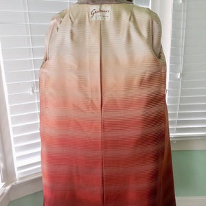 May include: A brown fur coat with a satin lining that has a gradient from cream to red. The coat has a label that says "Greisman's" on the back.