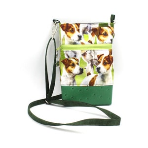 May include: A green and white crossbody phone bag with a zipper closure and a pattern of Jack Russell Terriers. The bag has a green adjustable strap.