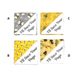May include: Four fabric bookmarks with a bee theme. Each bookmark is a square with a diagonal cut. The top half of each bookmark is a different bee-themed fabric. The bottom half of each bookmark is white with the text "I'll Save Your Page" printed in black.