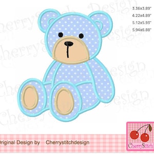 May include: A blue teddy bear with white polka dots sitting with its legs crossed. The bear has a light brown nose and eyes.
