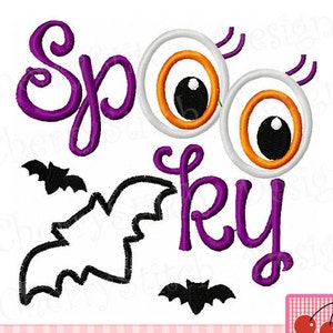 May include: Purple and black embroidery design with the text "Spooky" and two large cartoon eyes with orange and black pupils. There are also two small black bats.