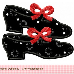 May include: A pair of black shoes with white polka dots and red bows. The shoes are a classic style with a rounded toe and a low heel.