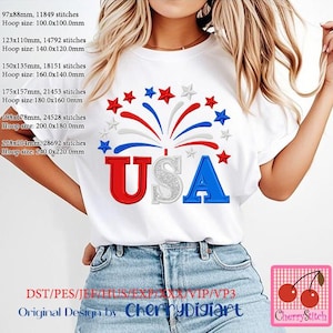 May include: A white t-shirt with a red, white, and blue embroidered design of fireworks and the word "USA".