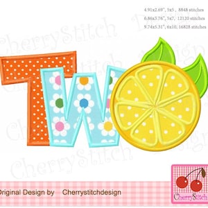 May include: Embroidered design of the word "TWO" in orange and blue with white polka dots and flowers. A yellow lemon slice with green leaves is next to the word.