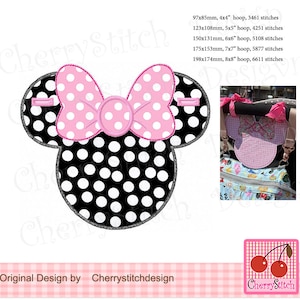 May include: A black and white polka dot Minnie Mouse-shaped design with a pink bow and white polka dots. The design includes the text "Original Design by Cherrystitchdesign".