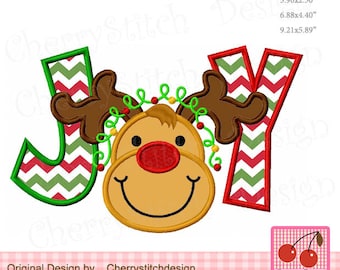 May include: A Christmas-themed embroidery design featuring the word "JOY" with a reindeer head in the middle of the "O". The letters are green and red with a chevron pattern. The reindeer has brown antlers, a red nose, and a brown face with a smile.