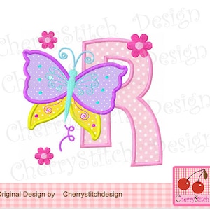 May include: Embroidered design of a pink letter R with white polka dots, a purple and yellow butterfly with a turquoise body, and pink flowers. The design is on a white background.