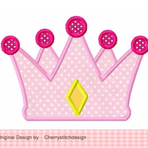 May include: Pink crown with white polka dots and a yellow diamond in the center. The crown has five pink circles with white polka dots on top.