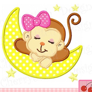 May include: A yellow crescent moon with white polka dots and a sleeping brown monkey with a pink bow on its head. The monkey is lying on its side with its arms crossed and its eyes closed. There are yellow stars in the background.