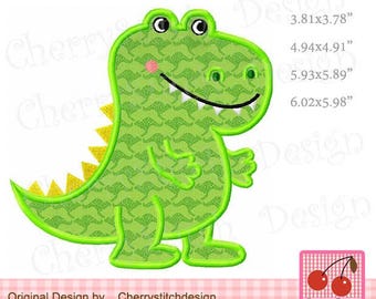 May include: Green dinosaur applique embroidery design with a yellow spiky tail and a friendly smile. The design is available in multiple sizes, ranging from 9.68 cm by 9.60 cm to 15.29 cm by 15.20 cm.